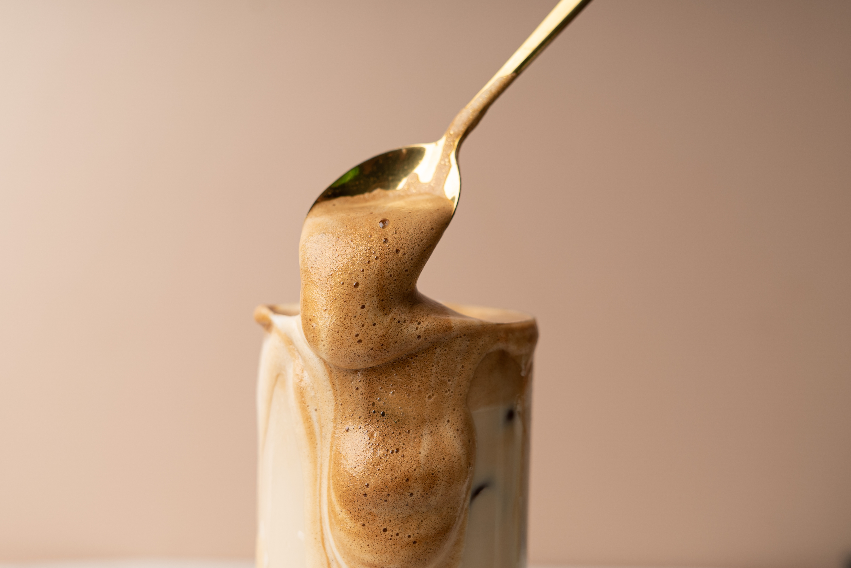 Dripping Coffee Froth in a Spoon and Glass